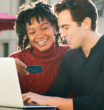 Young couple shopping online together with laptop and credit car